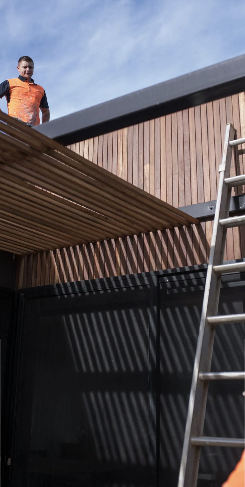 A fitter working on a retail shopfront installation.